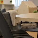 Modern interior with a wooden table and gray chair in a blurred room setting